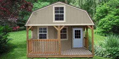The Deluxe Lofted Barn Cabin wrap-around front porch with rails, three 2 x 3 windows, one 9-light , pre-hung door and lofts on each end

