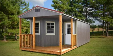 The Deluxe Cabin, wrap-around front porch with rails, three 2 x 3 windows and pre-hung door.